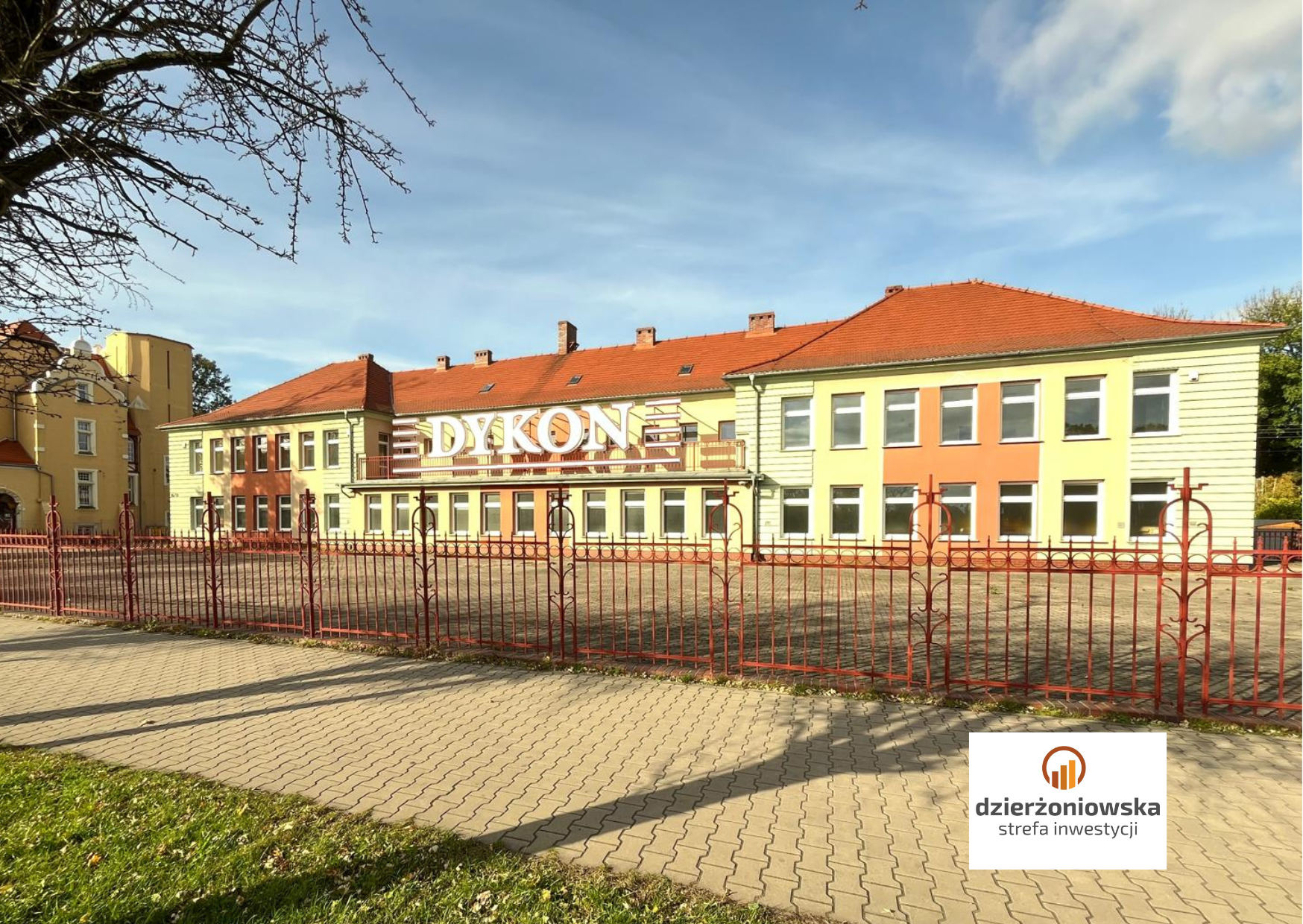 One-storey building with a colorful facade. The logo of Dzierżoniowska