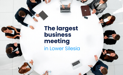 A group of people sitting around a round table. Text: “Business Mixer – The Largest Networking Event in Lower Silesia.”