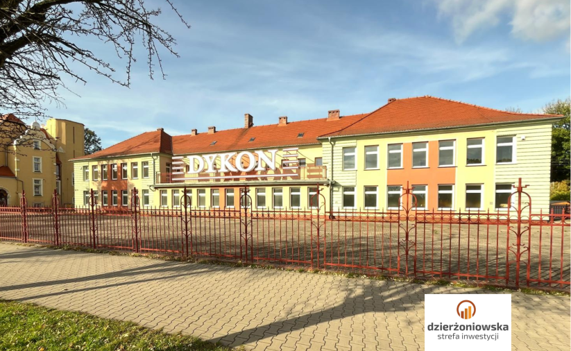 One-storey building with a colorful facade. The logo of Dzierżoniowska